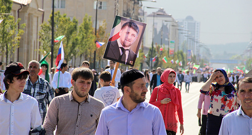 The participants of the celebratory marching holding a portrait of Kadyrov in the street of Grozny. September 2014. Photo by Magomed Magomedov for the "Caucasian Knot"