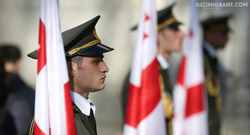 Serviceman under the flag of Georgia. Photo: http://www.geomigrant.com/2015/08/08/грузия-должна-объединиться-не-ценой-крови-а-ценой-любви-и-дружбы/