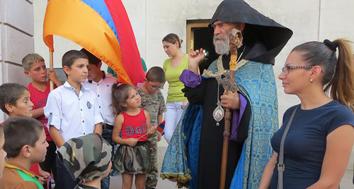 Archbishop Pargev Martirosyan, the leader of the Artsakh Diocese of the Armenian Apostolic Church, had a talk with children in Maraga village and blessed them after
the liturgy for the repose of the two soldiers lost on September 4 in the Karabakh conflict zone. Stepanakert, Nagorno-Karabakh. September 6, 2015. Photo by Alvard Grigoryan for the "Caucasian Knot"