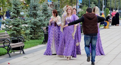 Man in Grozny performs national dance in front of the girls in national costumes. Photo by Magomed Magomedov for the ‘Caucasian Knot’. 