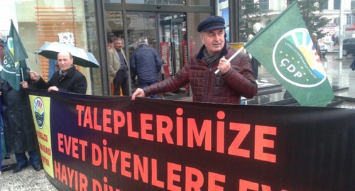 An activist with a poster in support of creating a television channel in the Circassian language in Turkey. Photo: Cerkesfed.org