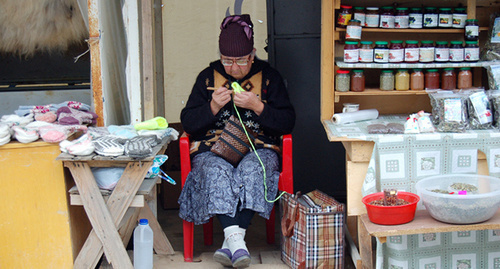 Resident of the village of Dombai is knitting clothing for sale. Photo by Leyla Gochiyaeva