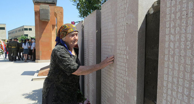 Shushan Ayrapetyan near the memorial with the carved names of people missed in the Karabakh war, including her own son. The Stepanakert Memorial Complex, Nagorno-Karabakh, June 29, 2017. Photo by Alvard Grigoryan for "Caucasian Knot"