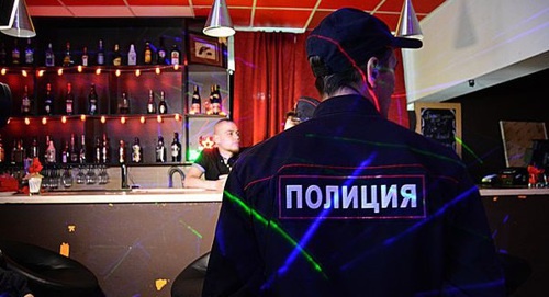 Policeman in a bar. Photo by Maria Mayer, IA 'Komiinform'