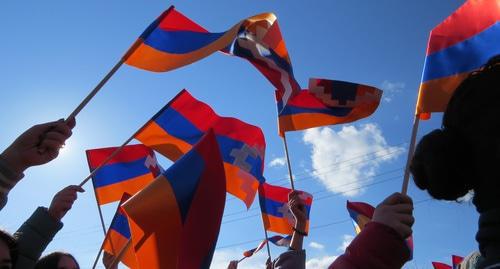 Residents of Stepanakert hold flags of Nagorno-Karabakh. Photo by Alvard Grigoryan for the Caucasian Knot. 
