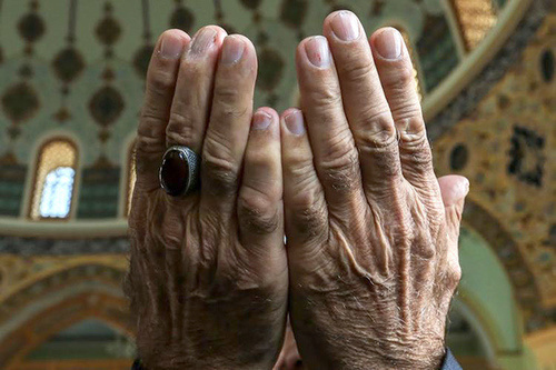 Hands of a praying believer. Photo by Aziz Karimov for the "Caucasian Knot"