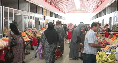Grozny resident at a food market on the eve of Eid al-Fitr. Screenshot of 'Grozny' TV Channel footage: https://www.youtube.com/watch?v=W39ZdVcGX0I