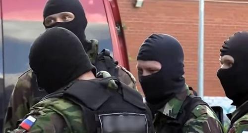 Law enforcers in masks. Screenshot of the video https://www.youtube.com/watch?v=ZsKHG3JRbso
