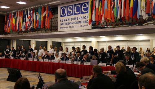 Action in support of Titiev and Sentsov at the OSCE conference in Warsaw, September 10, 2018. Photo from channel of the HRC "Memorial", https://web.telegram.org/#/im?p=@hrcmemorial