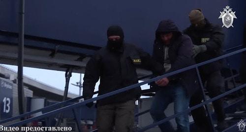 Detained Magomed Nurov (centre). Screenshot from video posted by the Investigative Committee of the Russian Federation, https://www.youtube.com/watch?time_continue=3&v=o6iwQMehugM