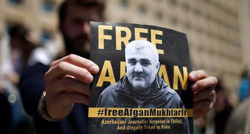 A poster with the photo of Afghan Mukhtarly. Photo: REUTERS/David Mdzinarishvili