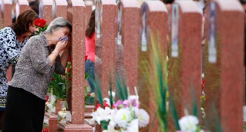 Grieving women at a cemetary in the town of Beslan on September 3, 2010. Photo: REUTERS / Kazbek Basaev