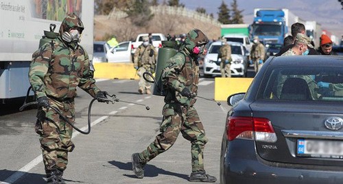 Georgian military spray a border checkpoint with disinfectant in Marneuli. Georgia, March 23, 2020. Photo: REUTERS/Irakli Gedenidz