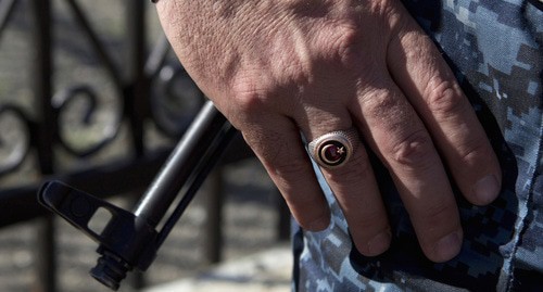 A hand of a law enforcer. Photo: REUTERS/Maxim Shemetov