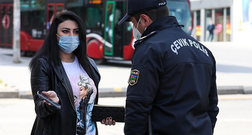A law enforcer checks the documents of a woman in Baku. Photo by Aziz Karimov for the "Caucasian Knot"