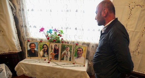Teimur Askerov standing next to the photos of his perished relatives. October 22, 2020. Photo by Aziz Karimov for the "Caucasian Knot"