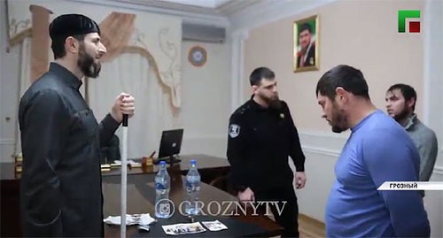 Adam Elzhurkaev, the chief physician of the Centre for Islamic Medicine, scolds the detainees in front of a law enforcer. Screenshot of the video by the "Grozny" TV Channel https://www.instagram.com/p/CI7pCFNJclV/