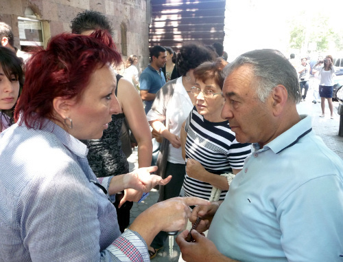 Residents of Yerevan discuss, during a protest action, dismantling of the indoor marketplace, Yerevan, May 28, 2012. Photo by Armine Martirosyan for the "Caucasian Knot"

 