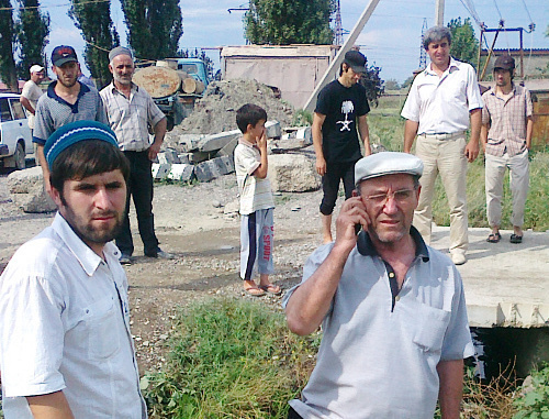 Villagers of Komsomolskoye ready to dismantle the pipe, used by "Acom" Factory to drain wastes into the canal. In the forefront – villager Rustam Shapiev and rights defender Murtazali Tagirov, Dagestan, Kizilyurt District, June 22, 2012. Photo by Patimat Makhmudova for the "Caucasian Knot"
