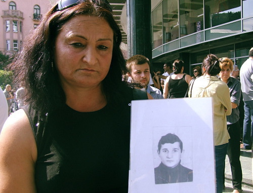 

Manana Abuseridze with a photo of her brother, who died from torture in Gldani Prison, Tbilisi, September 19, 2012. Photo by Edita Badasyan for the "Caucasian Knot"