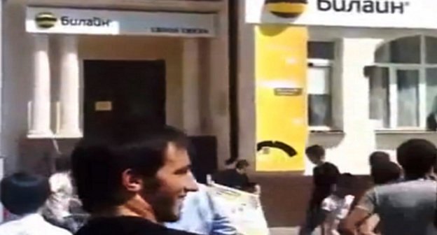 Young people throwing eggs at office of "Beeline". Chechnya, Grozny, August 30, 2013. Snapshot of a video published at YouTube