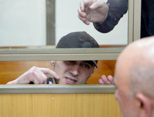 Convicted Yusup Dzangiev talks to his father in the courtroom in the North-Caucasian District Military Court. Rostov-on-Don, April 8, 2014. Photo by Oleg Pchelov for the "Caucasian Knot"