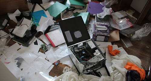 Broken personal computer lying on the heap of papers
