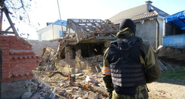 Law enforcer in front of the house destroyed during special operation, Chegem-Vtoroi village, Kabardino-Balkaria, November 2014. Photo: http://nac.gov.ru
