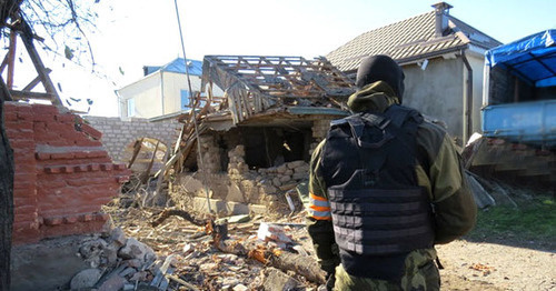 Law enforcer in front of the house destroyed during special operation, Chegem-Vtoroi village, Kabardino-Balkaria, November 2014. Photo: http://nac.gov.ru