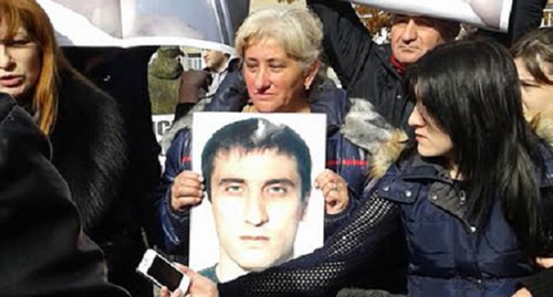 Woman holds a photo of Vladimir Tskaev. Photo by Emma Marzoeva for the "Caucasian Knot"