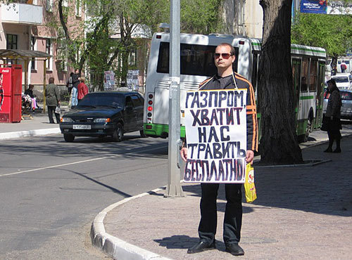 Activist with a poster at the LLC "Gazprom Dobycha Astrakhan". Poster: "Gazprom, stop poisoning us free of charge!" May 11, 2010. Photo by Alexander Alymov for "Caucasian Knot"