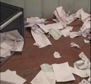 A broken ballot box and torn and trampled down ballot papers at the polling station in the village of Gotsatl. Screenshot of a video from the "Dagestan Online" community on Facebook, facebook.com/groups/dagonline