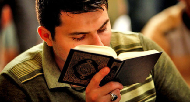 Young man reading Koran. Photo by Aziz Karimov for the 'Caucasian Knot'. Young man reading Koran. Photo by Aziz Karimov for the 'Caucasian Knot'.