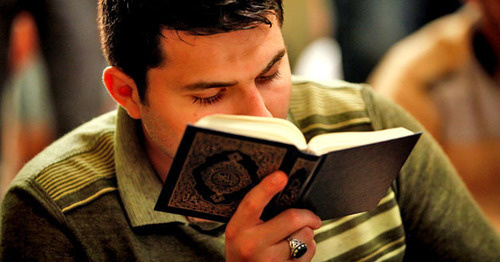 Young man reading Koran. Photo by Aziz Karimov for the 'Caucasian Knot'. 