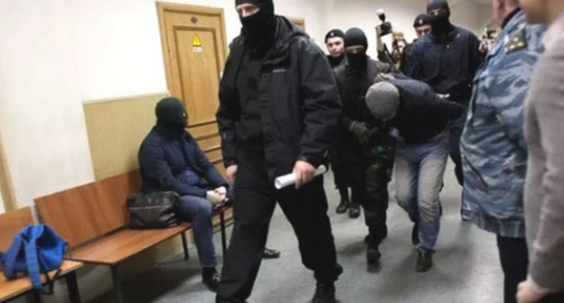 Shagid Gubashev, a defendant in the Boris Nemtsov's murder case, is convoyed through the corridor of the Basmanny Court of Moscow. Photo: Centre for Investigative Journalism http://investigator.org.ua/news/150556/ Shagid Gubashev, a defendant in the Boris Nemtsov's murder case, is convoyed through the corridor of the Basmanny Court of Moscow. Photo: Centre for Investigative Journalism http://investigator.org.ua/news/150556/