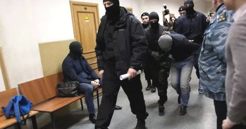 Shagid Gubashev, a defendant in the Boris Nemtsov's murder case, is convoyed through the corridor of the Basmanny Court of Moscow. Photo: Centre for Investigative Journalism http://investigator.org.ua/news/150556/ Shagid Gubashev, a defendant in the Boris Nemtsov's murder case, is convoyed through the corridor of the Basmanny Court of Moscow. Photo: Centre for Investigative Journalism http://investigator.org.ua/news/150556/