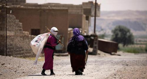 Women with white frag in Raqqa, Syria. Photo: Rodi Said/Reuters