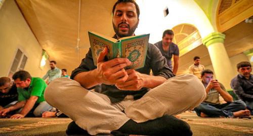 A believer is reading the Quran. Photo by Aziz Karimov for the "Caucasian Knot"