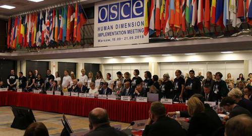 An actio in support of Oyub Titiev and Oleg Sentsov held at a conference of the OSCE. September 10, 2018. Photo from the Telegram Channel of the Human Rights Centre "Memorial" https://web.telegram.org/#/im?p=@hrcmemorial