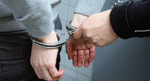 A man in handcuffs. Photo https://pixabay.com