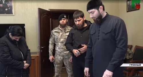 Detained Chechen woman, Adam Elzhurkaev, the chief physician of the Centre for Islamic Medicine in Grozn, and law enforcers. Screenshot from video posted by ChGTRK "Grozny" at: https://www.youtube.com/watch?v=yQ2EA0AUhDY&feature=emb_logo