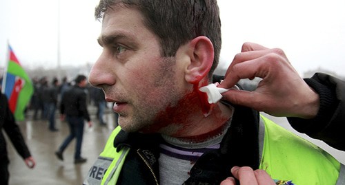 A journalist wounded during the protest action gets medical help. Baku, 2012. Photo: REUTERS/Abbas Atilay