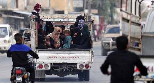 Women and children riding in a truck, October 2019. Photo: REUTERS/Khalil Ashawi