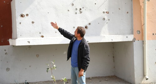 Traces of shelling attacks on a wall and balcony of a building in Azerbaijan. Photo by Aziz Karimov for the Caucasian Knot