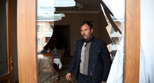 A man standing next to a broken window after shelling, Ganja, October 2020. Photo by Aziz Karimov for the "Caucasian Knot"