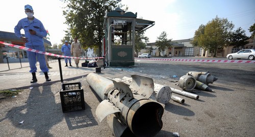 Azerbaijani investigator stands near fragments of weapons at the street in Barda damaged as a result of shelling, October 29, 2020. Photo: REUTERS/Aziz Karimov