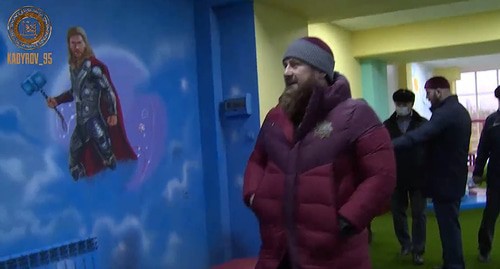 Ramzan Kadyrov near the images of characters from US movies and Marvel comics on the walls of the children's centre in Kurchaloi. Screenshot of Ramzan Kadyrov's post on the VKontakte https://vk.com/ramzan?w=wall279938622_543529&amp;z=video279938622_456243691%2F521a68267418560268%2Fpl_post_279938622_543529