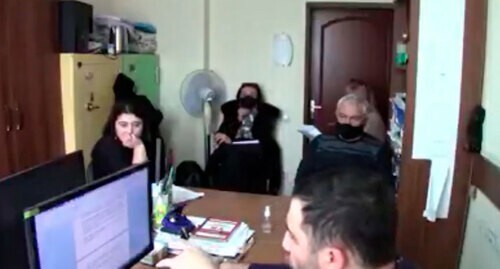 Interrogation of Zarina Dzagoeva (far left). Screenshot: http://youtu.be/D3LDhcQQAS8