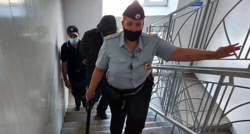 Policemen accompany Alexander Gusev in the courthouse. Photo: Court Department for the Novosibirsk Region