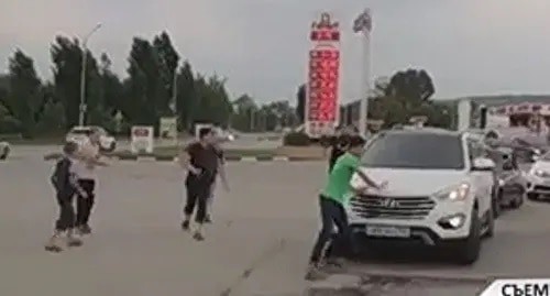 A group of teenagers block passage of wedding corteges asking for money rewards according to the Chechen tradition. Screenshot: https://www.instagram.com/p/CVYe41yob5Z/